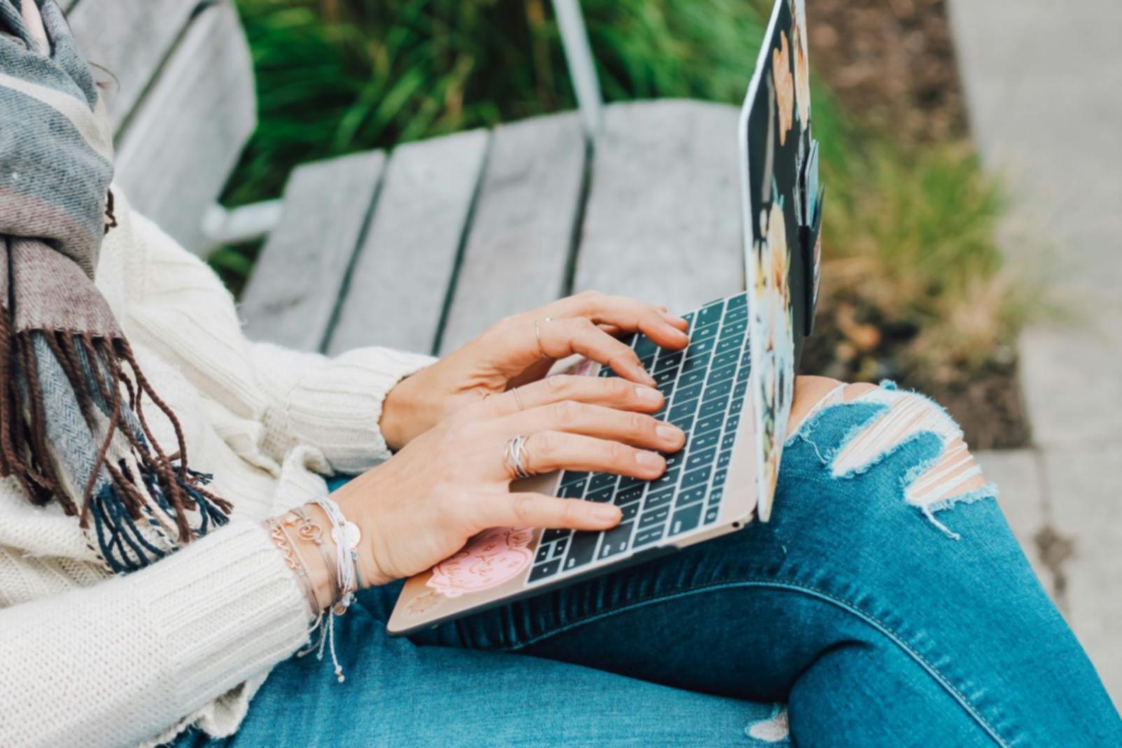 International student working on financial planning at desk with laptop and documents